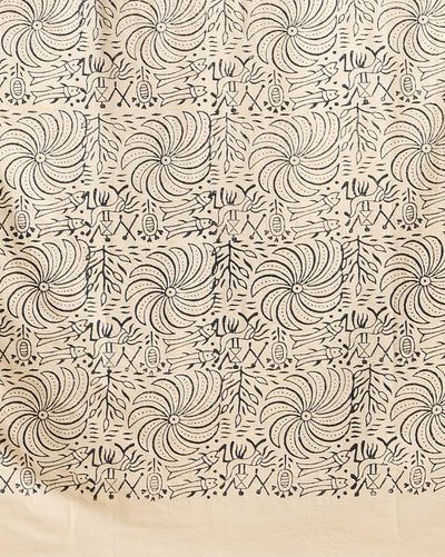 Off white and slate blue Katan silk unstitched suit set hand block printed with stylised swirls and fish motifs in an asymmetric repeat, with teal and charcoal grey accents and fringed edges.