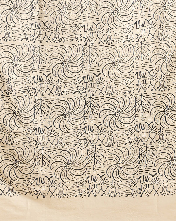 Off white and slate blue Katan silk unstitched suit set hand block printed with stylised swirls and fish motifs in an asymmetric repeat, with teal and charcoal grey accents and fringed edges.