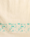 Off white and slate blue Katan silk unstitched suit set hand block printed with stylised swirls and fish motifs in an asymmetric repeat, with teal and charcoal grey accents and fringed edges.