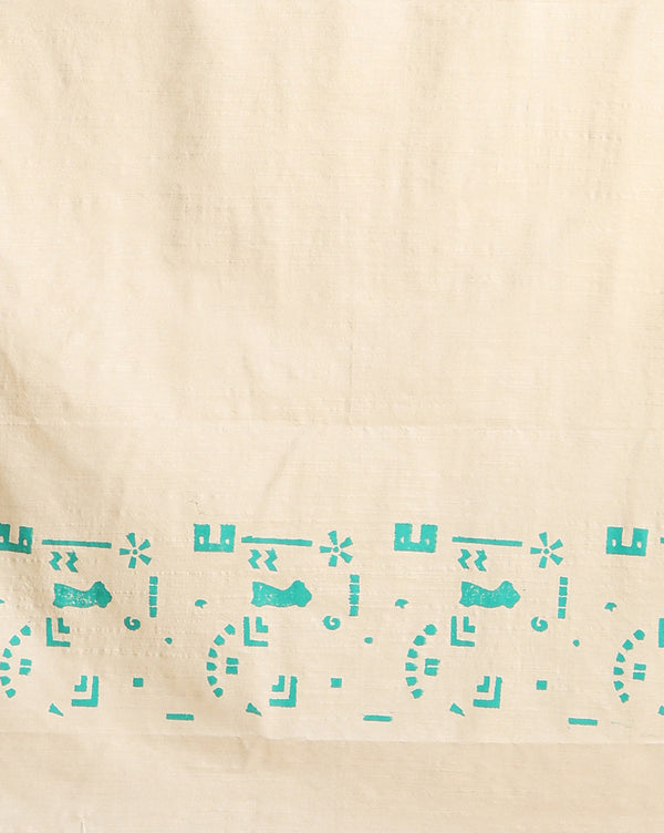 Off white and slate blue Katan silk unstitched suit set hand block printed with stylised swirls and fish motifs in an asymmetric repeat, with teal and charcoal grey accents and fringed edges.