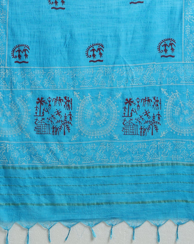 Sky blue Katan silk unstitched suit set block printed with tribal figures and circular mandalas in bright and light blue on the top piece, a dupatta bordered with linear geometric bands, and a plain bottom piece.