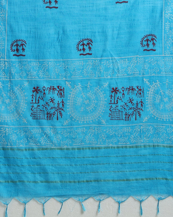 Sky blue Katan silk unstitched suit set block printed with tribal figures and circular mandalas in bright and light blue on the top piece, a dupatta bordered with linear geometric bands, and a plain bottom piece.
