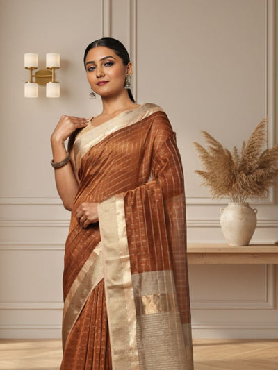 Earthy brown handloom Maheshwari silk saree with allover checks and a wide golden contrast pallu