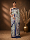 Cream printed Kashmiri silk saree with a multi-coloured Madhubani-style figurative print of florals, elephants and peacocks, a solid navy border, and a pallu of horizontal elephant registers.