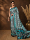 White, teal and dark grey paisley printed saree with a wide striped teal and grey border, styled with a reference blouse.