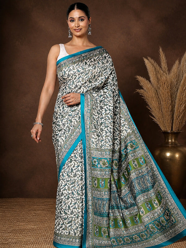 White Kashmiri Silk printed saree with an all-over paisley, floral and vine print in blue and green, a wide blue-and-green pallu panel and a narrow teal-blue border.