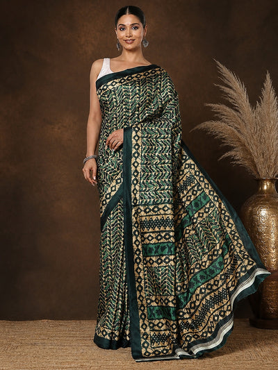 Forest green and gold geometric printed saree with chevron and diamond motifs and a striped end-panel, styled with a reference blouse.