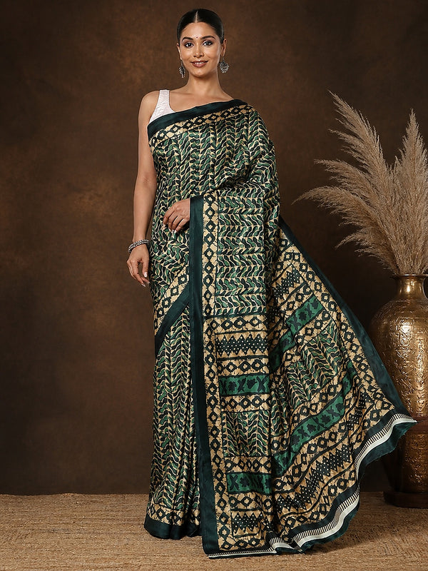 Forest green and gold geometric printed saree with chevron and diamond motifs and a striped end-panel, styled with a reference blouse.