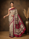 Beige printed Kashmiri silk saree with a magenta Warli-style figurative print of tribal figures and huts, a large magenta pallu panel of village scenes, and a narrow magenta border.