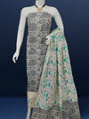 Off white and slate blue Katan silk unstitched suit set hand block printed with stylised swirls and fish motifs in an asymmetric repeat, with teal and charcoal grey accents and fringed edges.